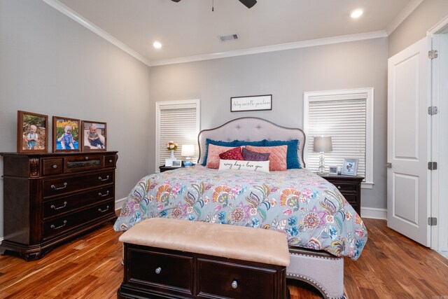 bedroom with hardwood / wood-style flooring, ceiling fan, and crown molding