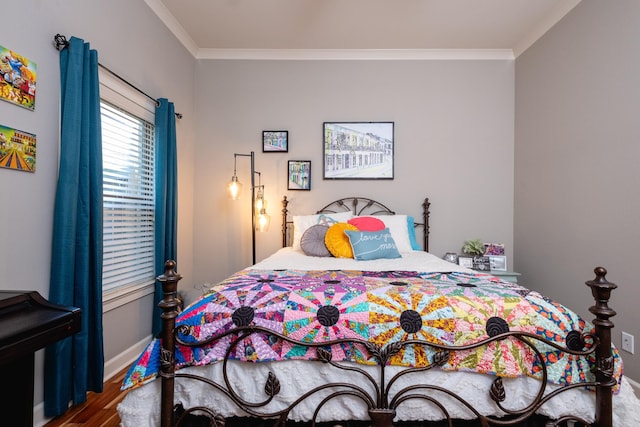 bedroom with crown molding and hardwood / wood-style flooring