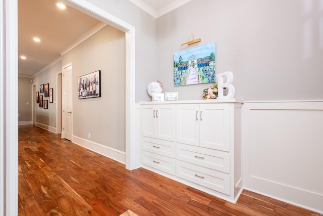 hall with hardwood / wood-style floors and crown molding