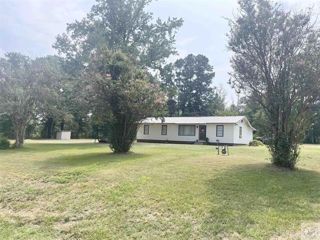 single story home featuring a front lawn