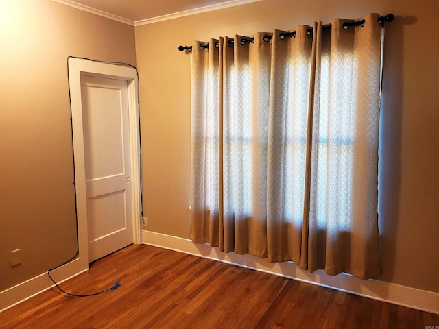 unfurnished room with wood-type flooring and ornamental molding