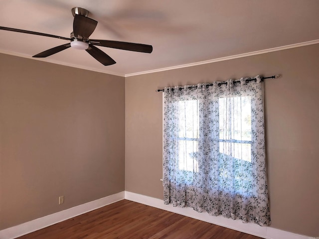 empty room featuring dark hardwood / wood-style floors, ceiling fan, and ornamental molding