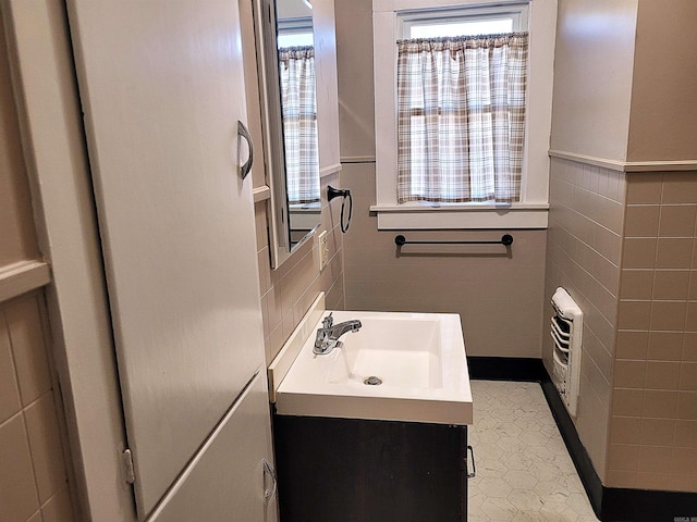 bathroom with vanity, tile patterned floors, and tile walls