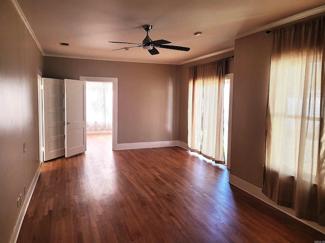 unfurnished room featuring dark hardwood / wood-style floors, ceiling fan, and crown molding