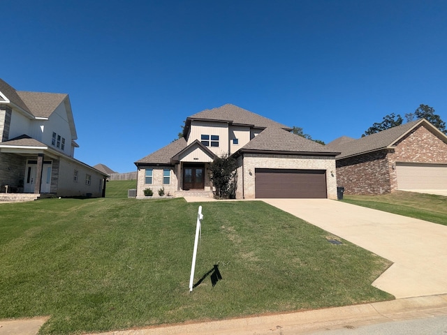 view of front facade with a garage and a front lawn