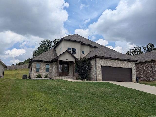 view of front of property featuring cooling unit, a front lawn, and a garage