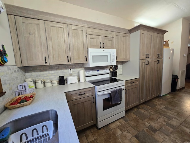 kitchen featuring light brown cabinets, white appliances, and tasteful backsplash