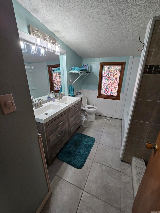 bathroom featuring vanity, a textured ceiling, and tile patterned floors