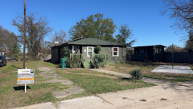 bungalow-style home with a front yard