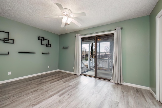 unfurnished room featuring a textured ceiling, light hardwood / wood-style floors, and ceiling fan