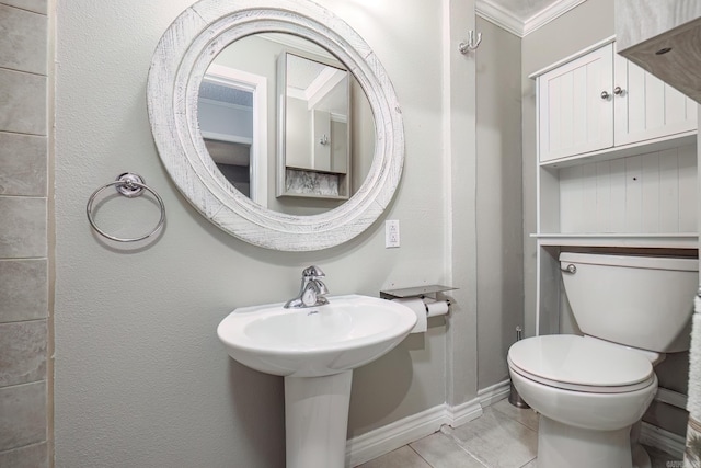 bathroom with tile patterned flooring, toilet, and crown molding