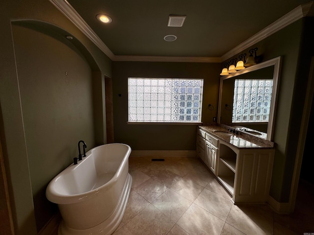 bathroom with a washtub, vanity, and crown molding