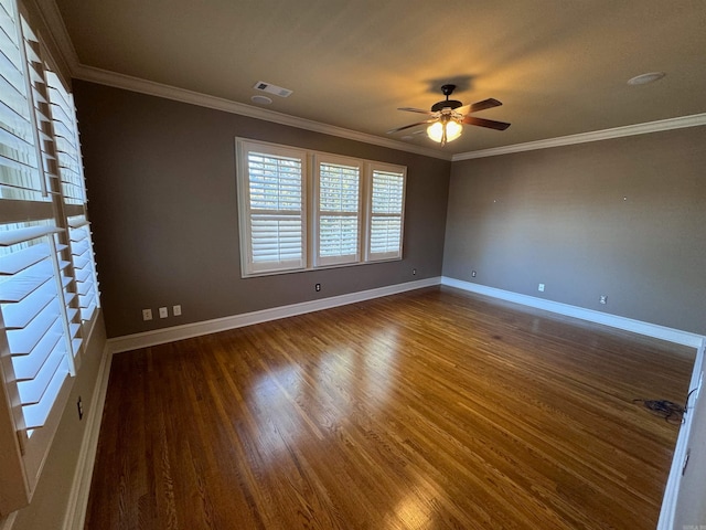 unfurnished room with ornamental molding, ceiling fan, and dark wood-type flooring