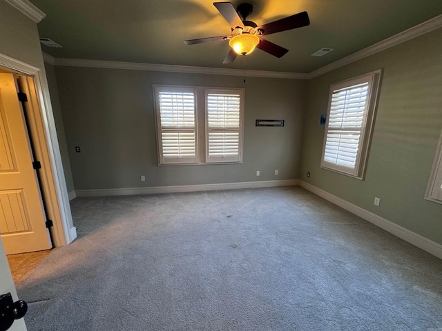 spare room featuring plenty of natural light, ornamental molding, and light carpet