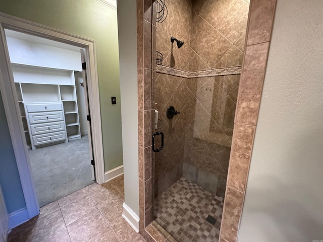 bathroom with tile patterned floors and a shower with shower door