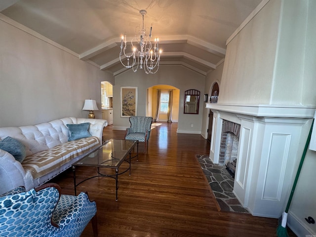 living room with a chandelier, dark hardwood / wood-style floors, and vaulted ceiling