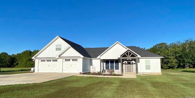 view of front of property with a garage and a front lawn