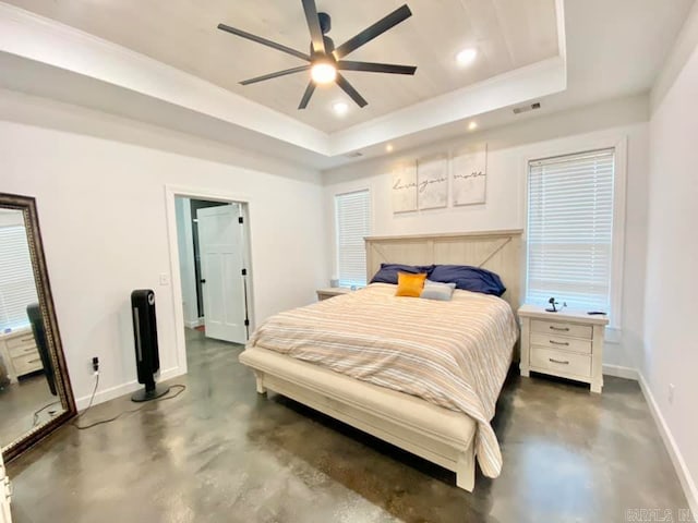 bedroom with a tray ceiling and ceiling fan