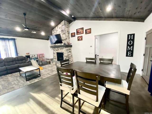 dining area featuring lofted ceiling with beams, ceiling fan, wooden ceiling, and a fireplace