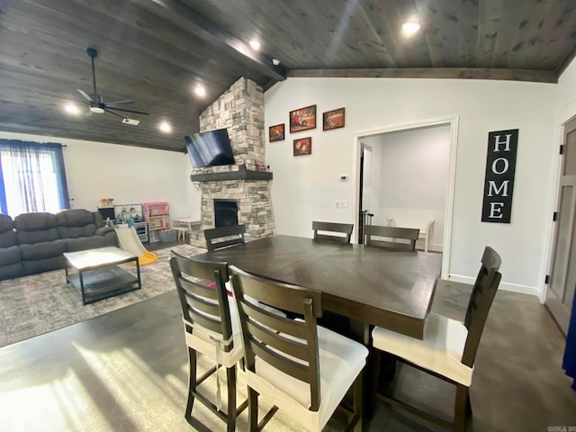 dining room featuring vaulted ceiling with beams, a stone fireplace, ceiling fan, and wood ceiling