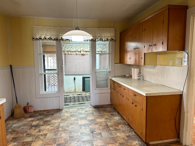 kitchen with decorative light fixtures and wooden walls