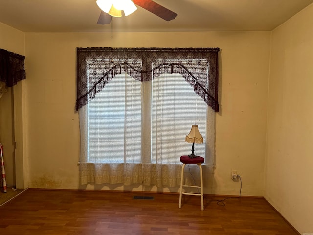 unfurnished room featuring hardwood / wood-style flooring and ceiling fan