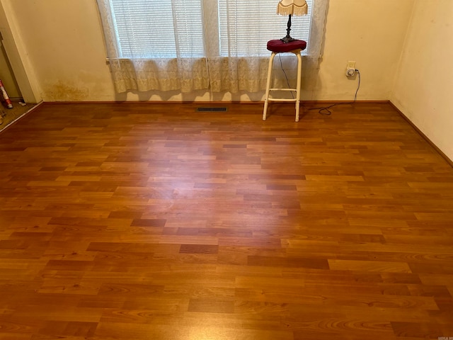 unfurnished room with hardwood / wood-style floors