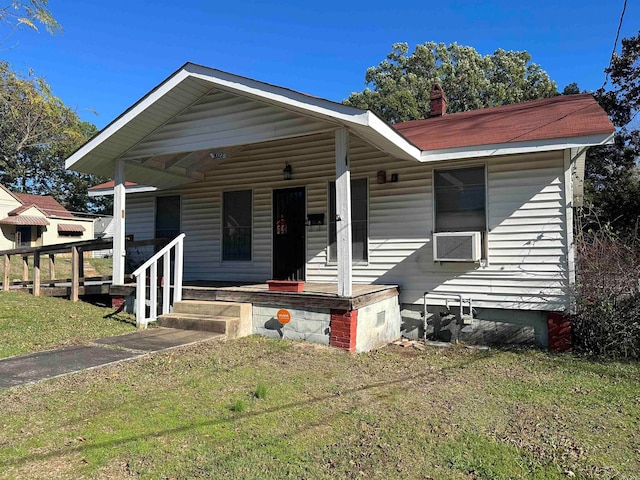 view of front of property with covered porch and a front yard