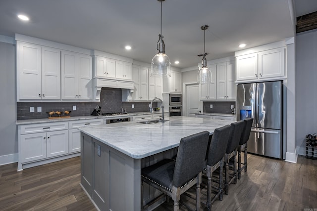 kitchen featuring a spacious island, white cabinetry, dark hardwood / wood-style flooring, and stainless steel appliances