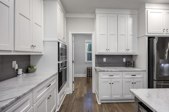 3025 Bordeaux Cv, Alexander, AR 72002 - kitchen with stainless steel appliances, white cabinetry, backsplash, and dark wood finished floors