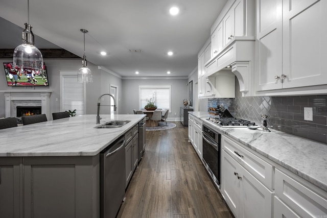 3025 Bordeaux Cv, Alexander, AR 72002 - kitchen featuring stainless steel appliances, a sink, white cabinetry, light stone countertops, and recessed lighting