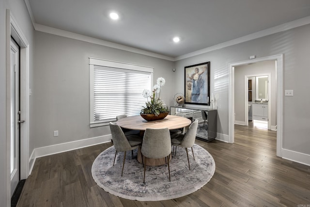 dining room featuring dark hardwood / wood-style floors and crown molding