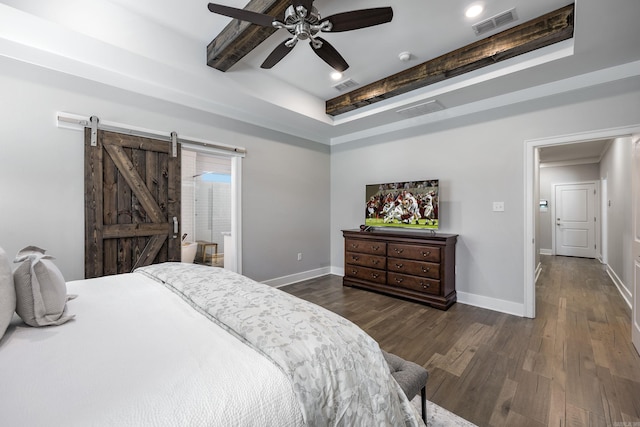 bedroom featuring beam ceiling, a barn door, ceiling fan, and dark wood-type flooring