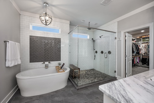 bathroom with tile patterned flooring, vanity, a chandelier, and independent shower and bath