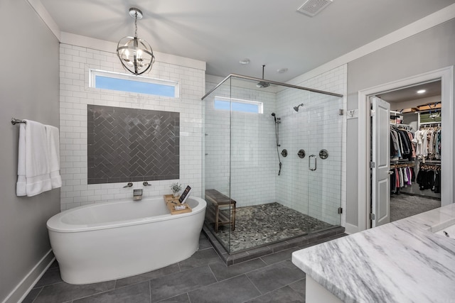 3025 Bordeaux Cv, Alexander, AR 72002 - bathroom featuring a shower stall, a freestanding tub, healthy amount of natural light, and tile patterned floors