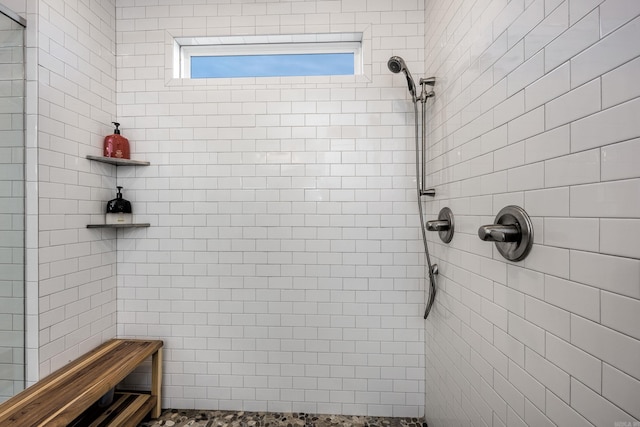 bathroom with a tile shower