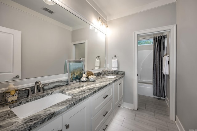 bathroom with vanity, shower / tub combo with curtain, and ornamental molding