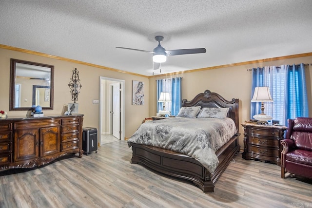 bedroom featuring ceiling fan, light hardwood / wood-style floors, and ornamental molding