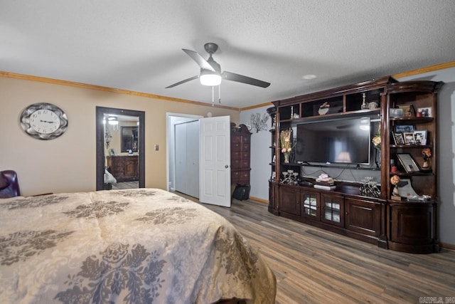 bedroom featuring ceiling fan, crown molding, dark wood-type flooring, and a textured ceiling