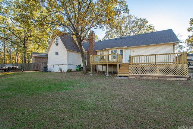 back of property featuring a lawn, a wooden deck, and central AC unit