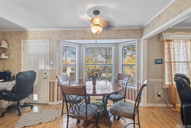 dining room featuring plenty of natural light, a textured ceiling, and light hardwood / wood-style flooring