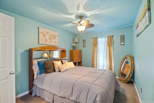 bedroom with carpet flooring, ceiling fan, and a textured ceiling