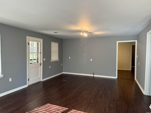 unfurnished room with dark hardwood / wood-style floors