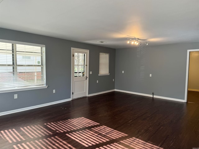 unfurnished room with dark hardwood / wood-style floors