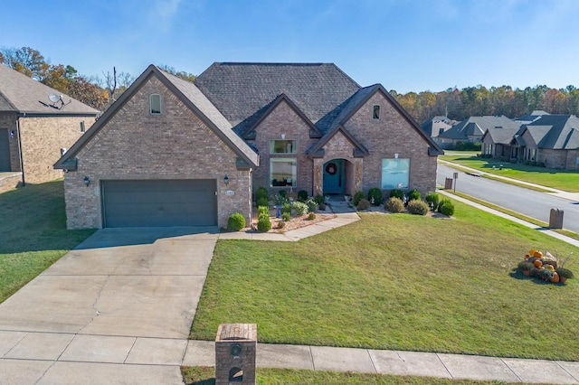 view of front of home featuring a garage and a front lawn