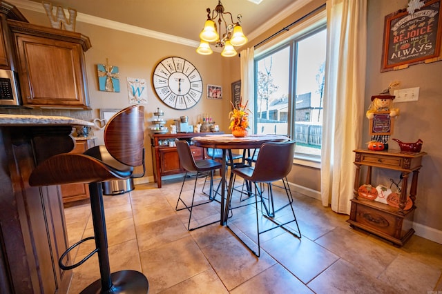 dining room with crown molding, light tile patterned floors, and a notable chandelier