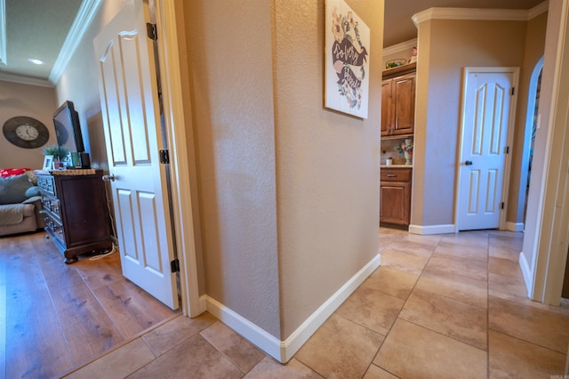 corridor featuring light hardwood / wood-style floors and ornamental molding