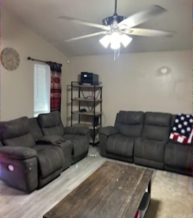 living room with hardwood / wood-style floors, ceiling fan, and lofted ceiling