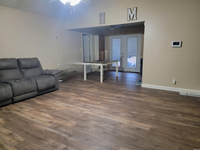 living room with ceiling fan, dark wood-type flooring, and high vaulted ceiling