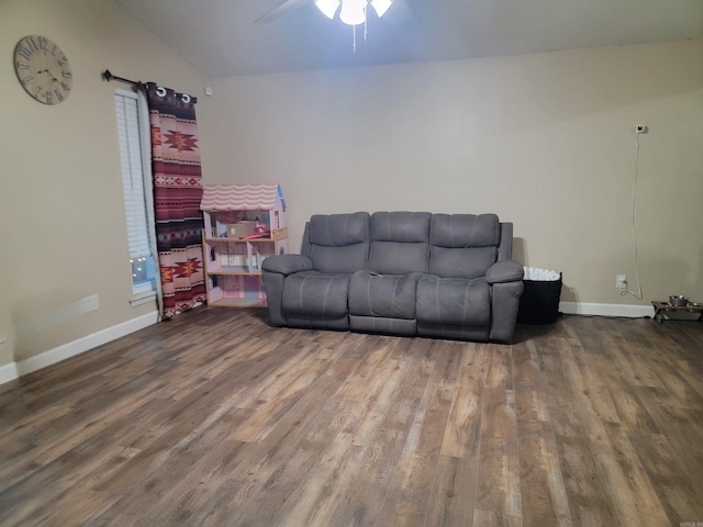 living room featuring dark hardwood / wood-style floors, ceiling fan, and lofted ceiling